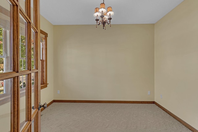 2008 11th St N, Sartell, MN 56377 - carpeted spare room with a chandelier and baseboards