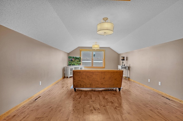2008 11th St N, Sartell, MN 56377 - office area featuring wood-type flooring, baseboards, vaulted ceiling, and a textured ceiling