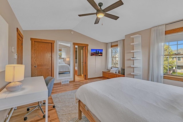 2008 11th St N, Sartell, MN 56377 - bedroom with light wood-style flooring, vaulted ceiling, multiple windows, and an office area