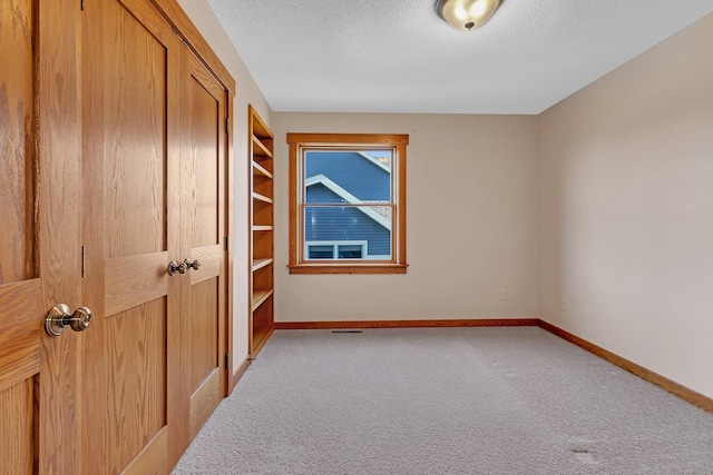 2008 11th St N, Sartell, MN 56377 - unfurnished bedroom with carpet floors, a textured ceiling, baseboards, and a closet
