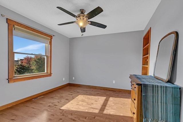 2008 11th St N, Sartell, MN 56377 - unfurnished living room featuring light wood-style floors, baseboards, and a ceiling fan