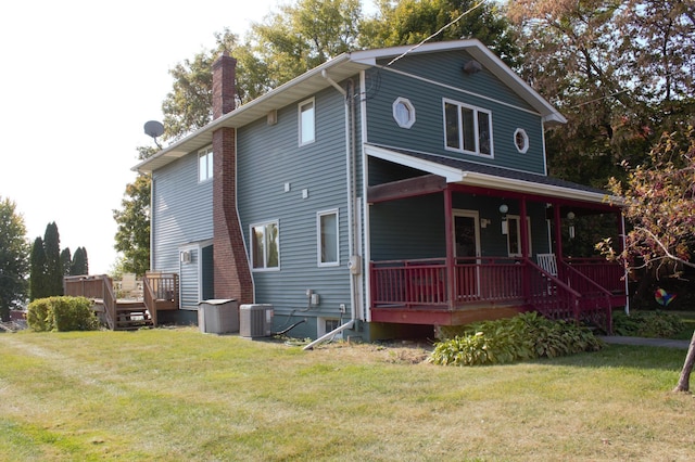 view of front of property with a front lawn and central AC