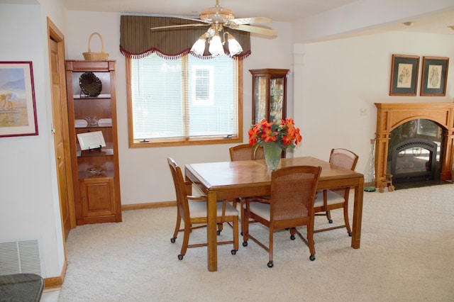 carpeted dining area featuring ceiling fan