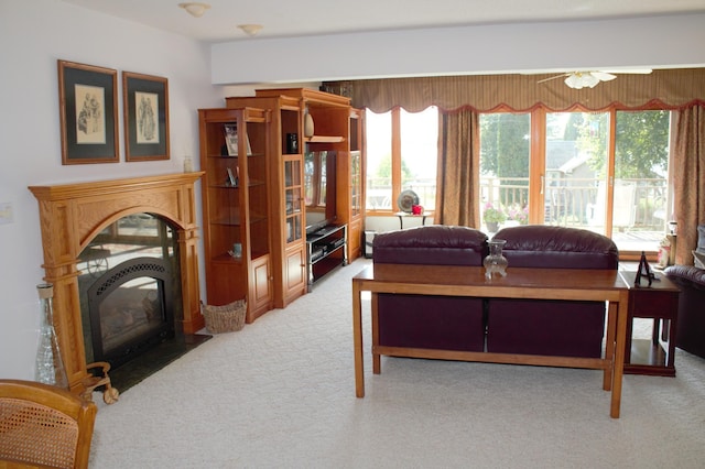 carpeted living room with ceiling fan