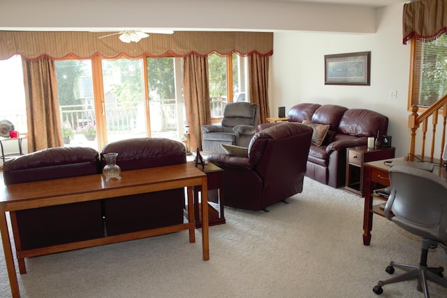 carpeted living room featuring ceiling fan and a wealth of natural light