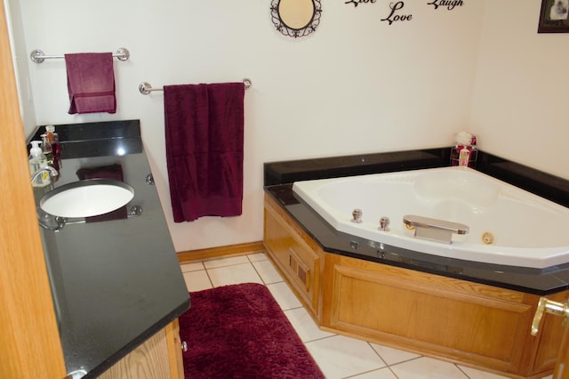 bathroom with tile patterned floors, a bathing tub, and sink