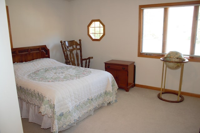 carpeted bedroom featuring multiple windows