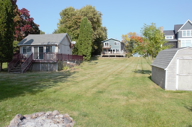 view of yard with a deck and a storage shed