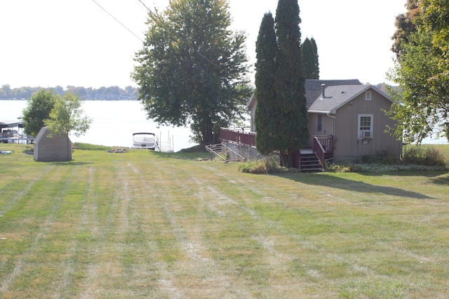 view of yard featuring a deck with water view