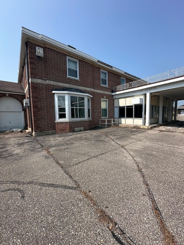 back of property with a garage