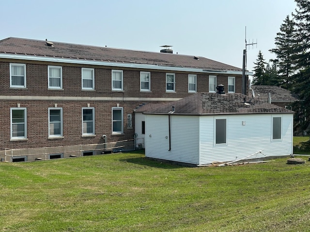 rear view of house featuring a lawn