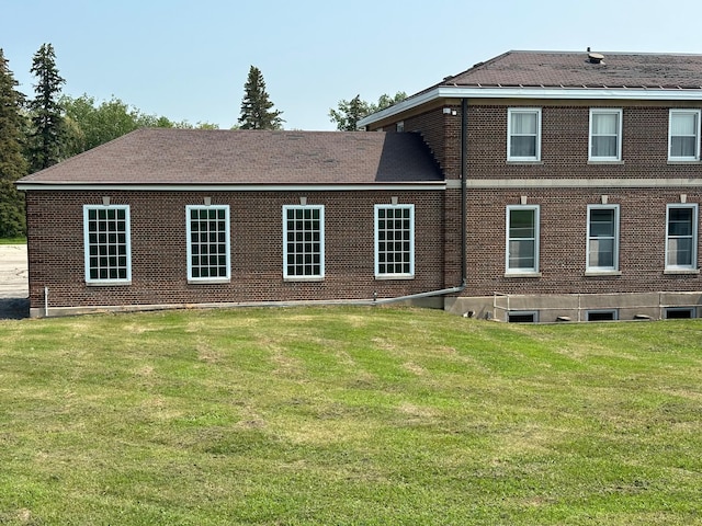 rear view of property featuring a yard