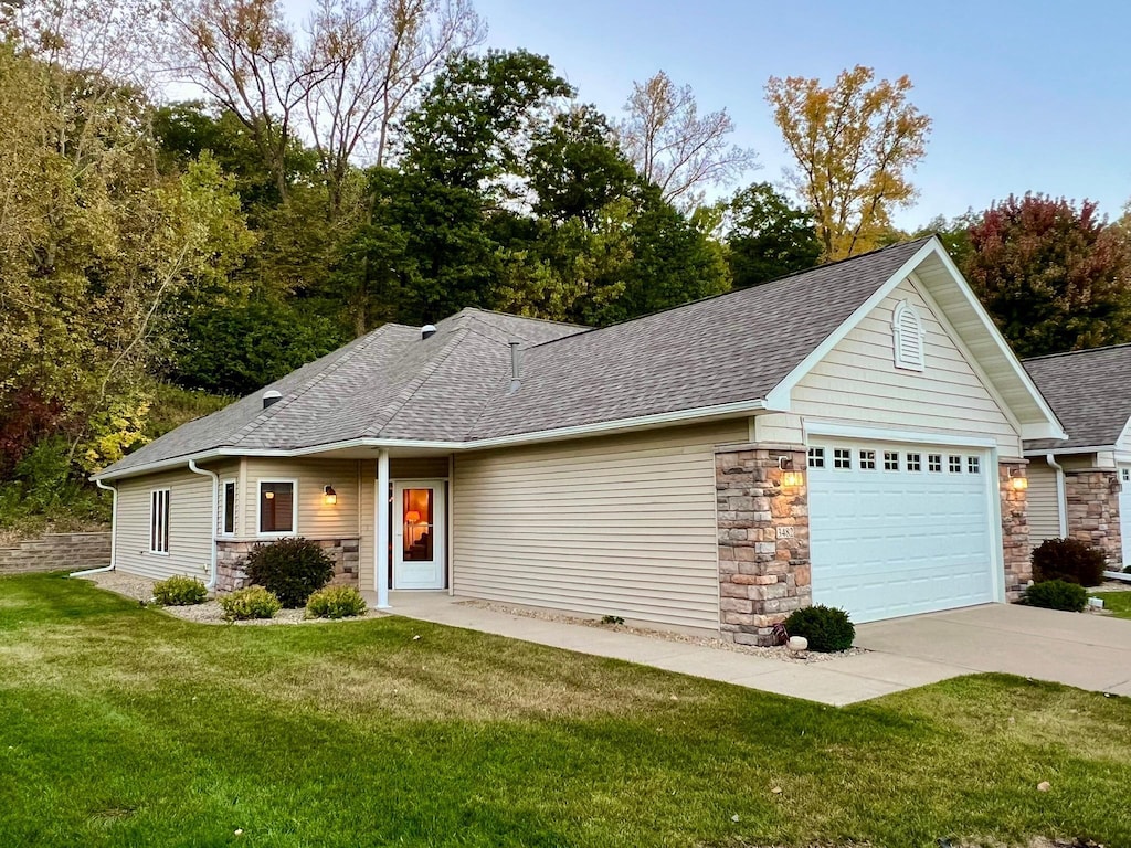 view of front of property with a garage and a front lawn