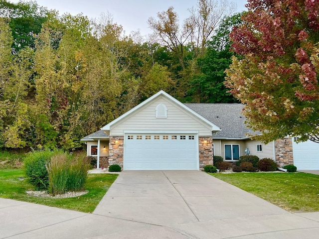 view of front of property with a garage and a front yard