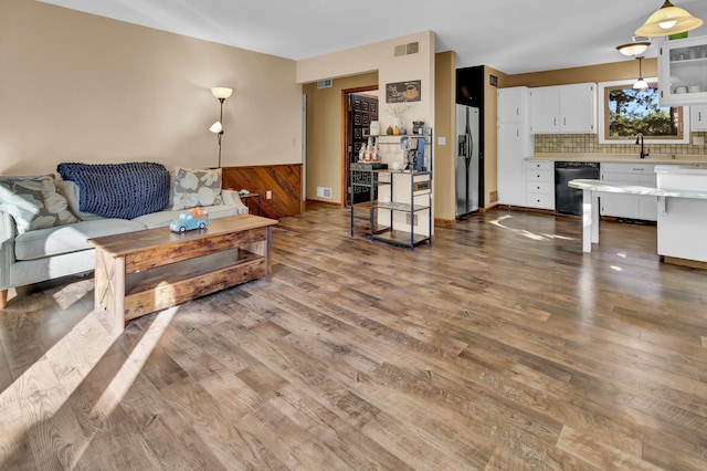 living room with hardwood / wood-style flooring and sink