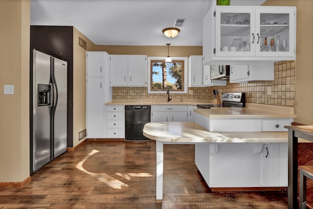 kitchen featuring dark hardwood / wood-style floors, sink, white cabinetry, appliances with stainless steel finishes, and decorative light fixtures