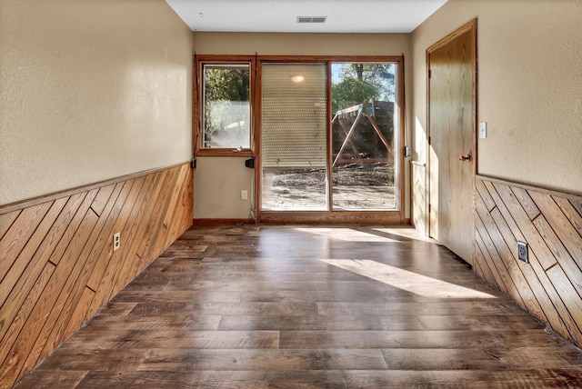 entryway with wooden walls and dark hardwood / wood-style floors