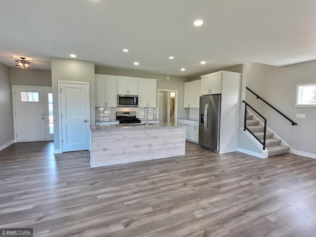 65164 365th St, Watkins, MN 55389 - kitchen featuring recessed lighting, baseboards, a sink, stainless steel appliances, and white cabinets