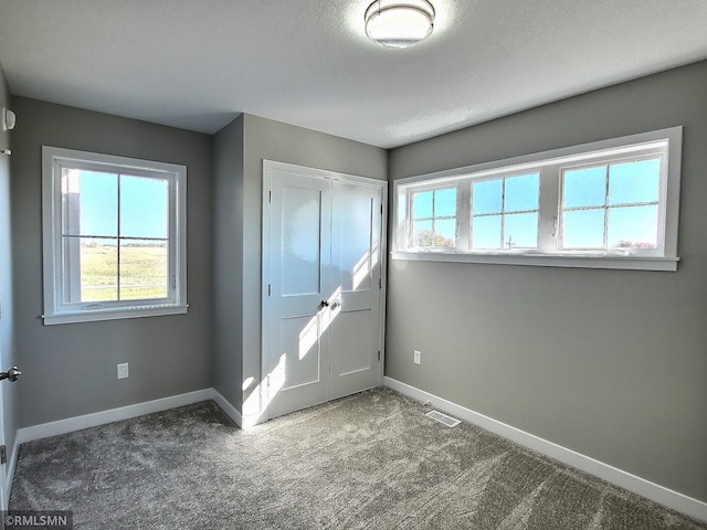 carpeted entrance foyer with a textured ceiling