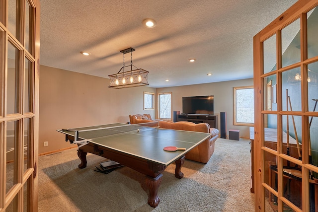 playroom featuring a textured ceiling and light colored carpet