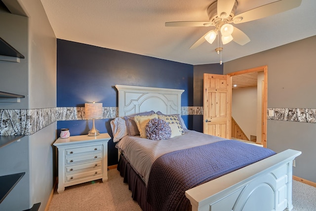 carpeted bedroom with a textured ceiling and ceiling fan