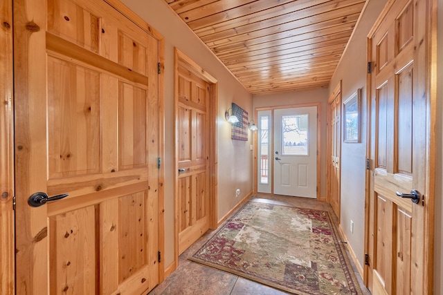 entryway featuring wood ceiling and tile patterned floors