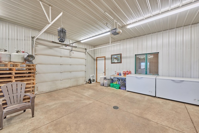 garage with a garage door opener and refrigerator