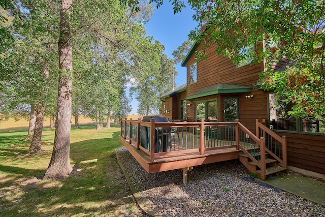 wooden terrace featuring a yard and area for grilling