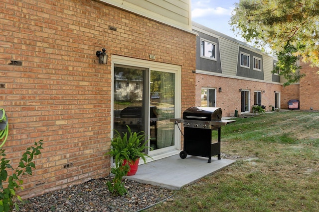 doorway to property with a patio and a lawn