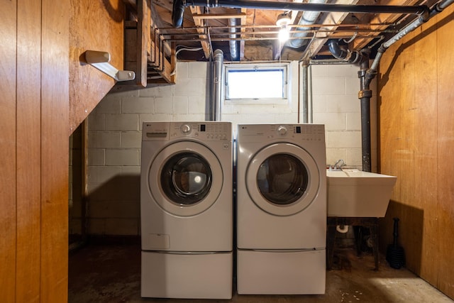 clothes washing area featuring sink and washer and dryer