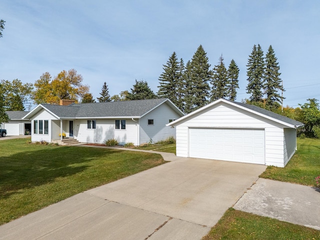 ranch-style home with an outbuilding, a garage, and a front yard