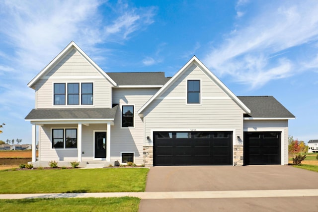 view of front facade featuring a garage and a front lawn