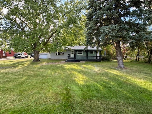 view of yard featuring a porch and a garage