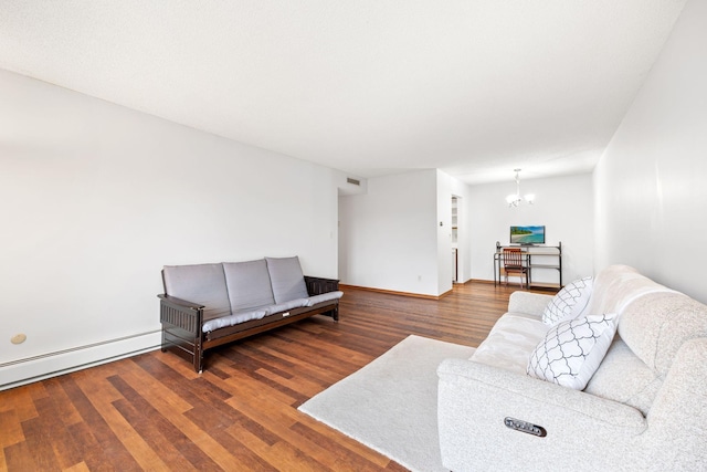 living room featuring a baseboard heating unit, dark hardwood / wood-style flooring, and a chandelier