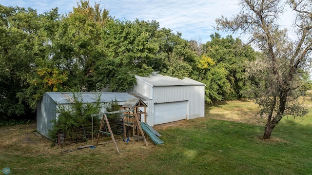 view of outdoor structure with a playground and a yard