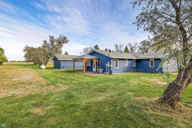 back of property with a lawn, an outbuilding, and cooling unit