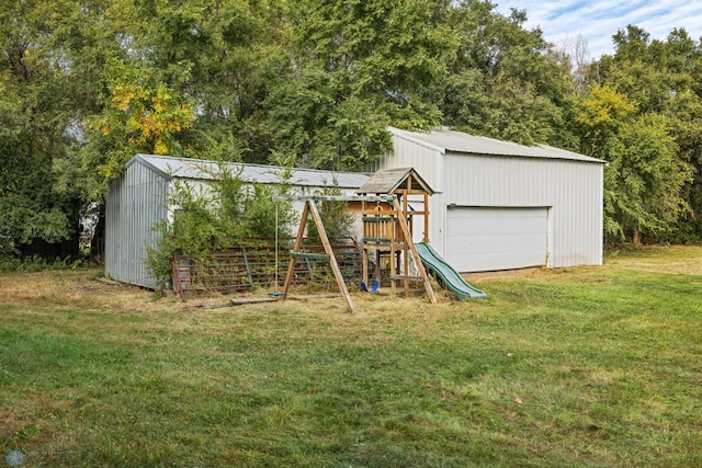 view of playground featuring an outdoor structure and a yard