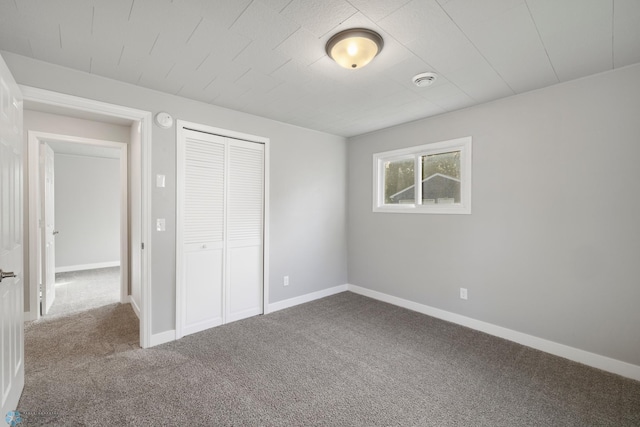 unfurnished bedroom featuring carpet floors and a closet