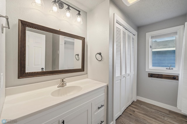 bathroom featuring vanity, a textured ceiling, and hardwood / wood-style flooring