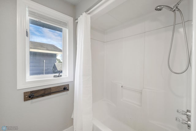 bathroom with shower / bathtub combination with curtain