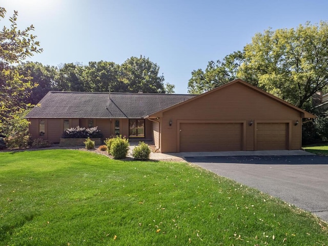 single story home with a garage and a front yard