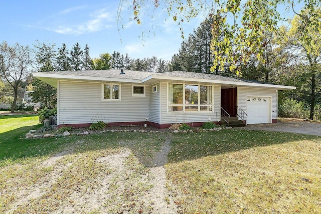 single story home with cooling unit, a front lawn, and a garage