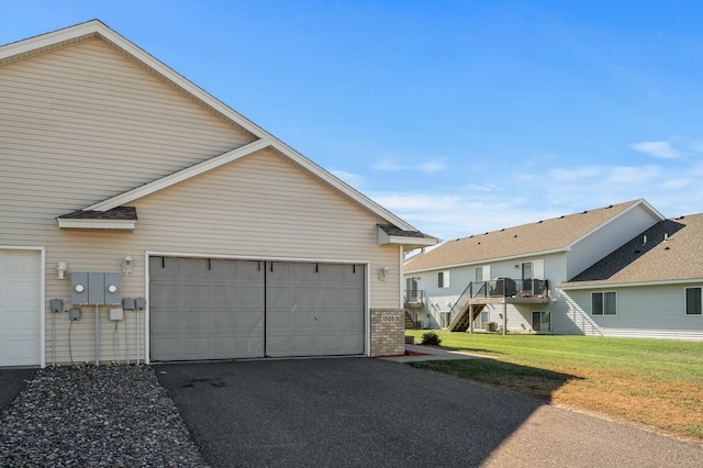 exterior space featuring a garage, a yard, and a wooden deck