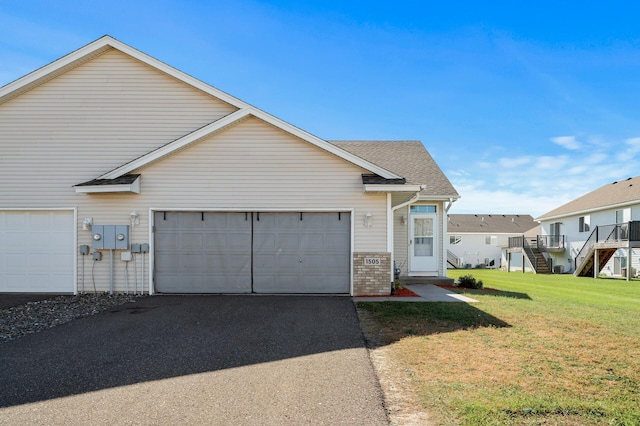 view of front facade with aphalt driveway, brick siding, stairway, a garage, and a front lawn