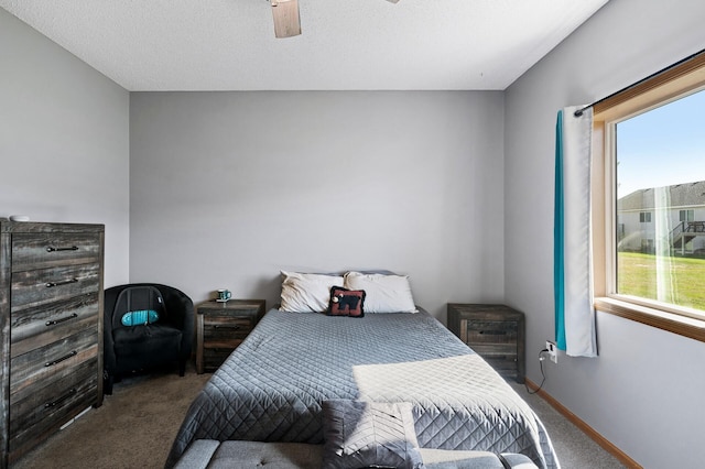 carpeted bedroom featuring ceiling fan and baseboards