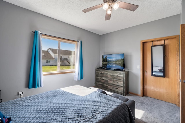 bedroom with baseboards, carpet, a ceiling fan, and a textured ceiling