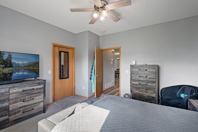 bedroom featuring light carpet, ceiling fan, visible vents, and baseboards