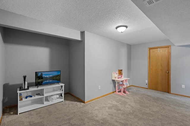 recreation room with carpet, visible vents, a textured ceiling, and baseboards