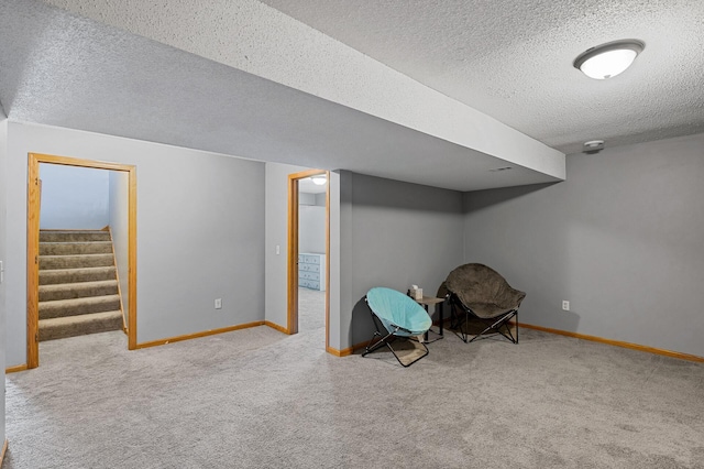 unfurnished room featuring baseboards, stairway, a textured ceiling, and light colored carpet