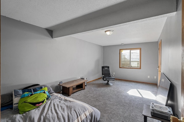 bedroom featuring a textured ceiling, carpet floors, and baseboards